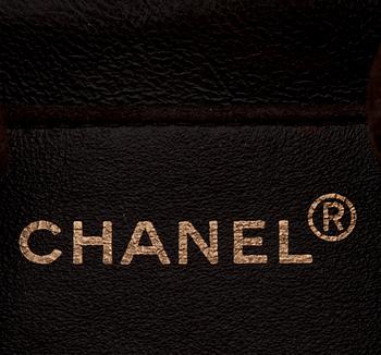 CHANEL, a brown suede shoulderpurse.