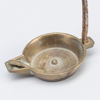 A 18th century oil lamp.