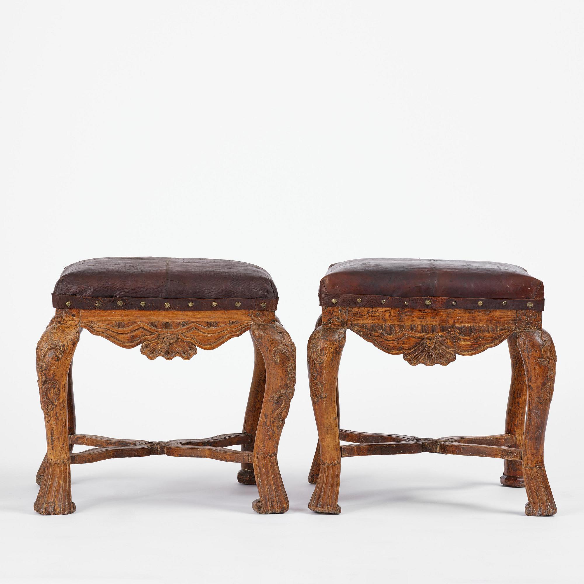 A pair of carved stools in the manner of Jonas Granberg, Jämtland, Sweden, mid 18th century.