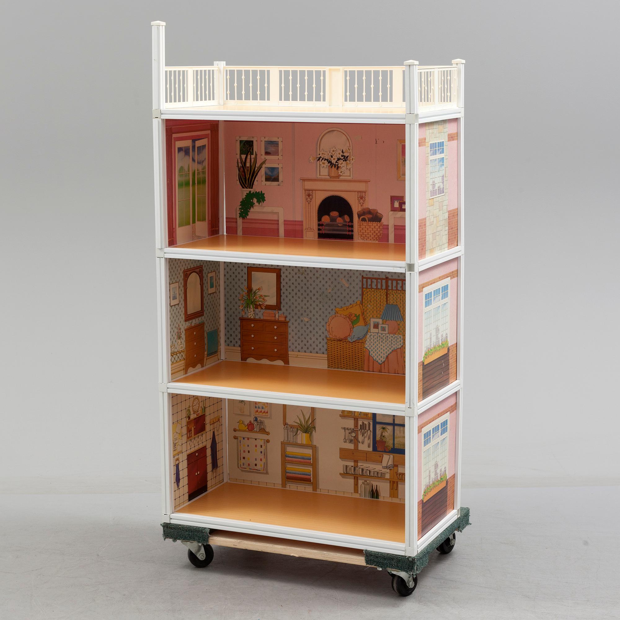 A plastic doll's house with six dolls, furniture and clothes, 20th century.