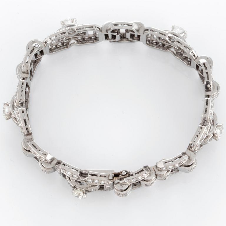 A platinum bracelet set with round brilliant- and eight-cut diamonds.