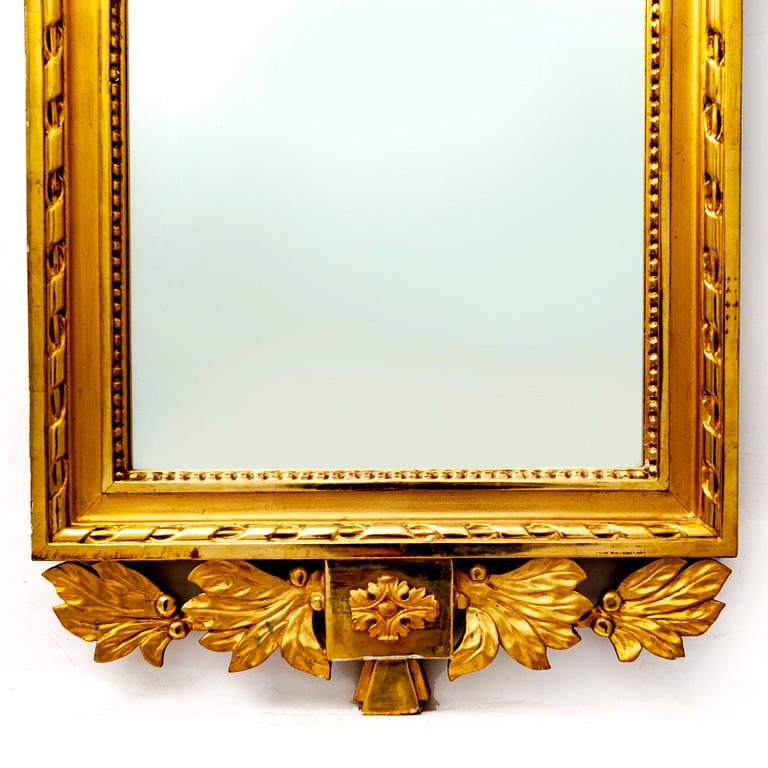 A gilded mid 1900s Gustavian style mirror.