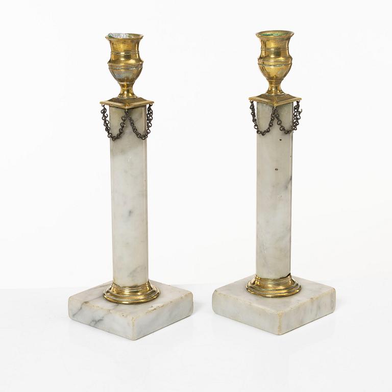 A pair of Gustavian brass and marble candlesticks, circa 1800.