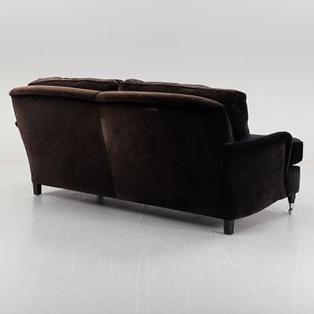 A contemporary velvet Howard sofa.