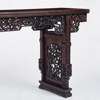 A massive zitan recessed-leg long table 'Jiaotousun Qiotouan', Qing dynasty, 19th century.