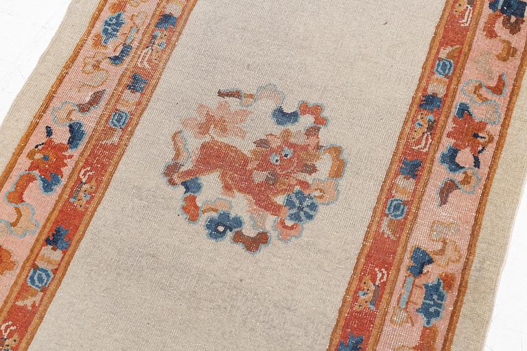 An antique / semi antique runner carpet, China, ca 300 x 96 cm.