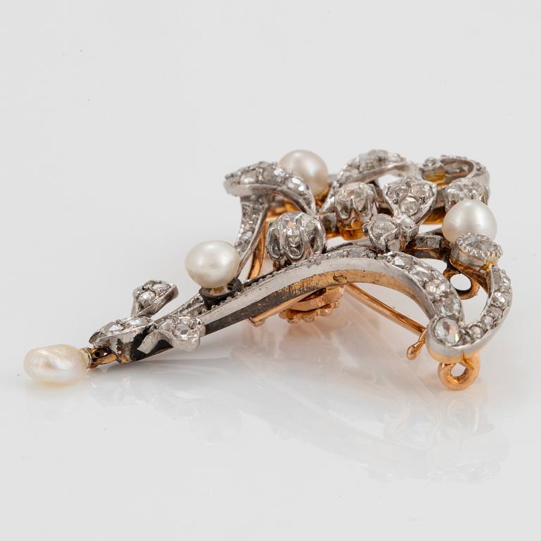 An 18K gold and platinum brooch set with old- and rose-cut diamonds.