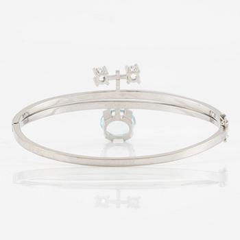 A bangle 18K white gold with aquamarine and two round brilliant-cut diamonds.