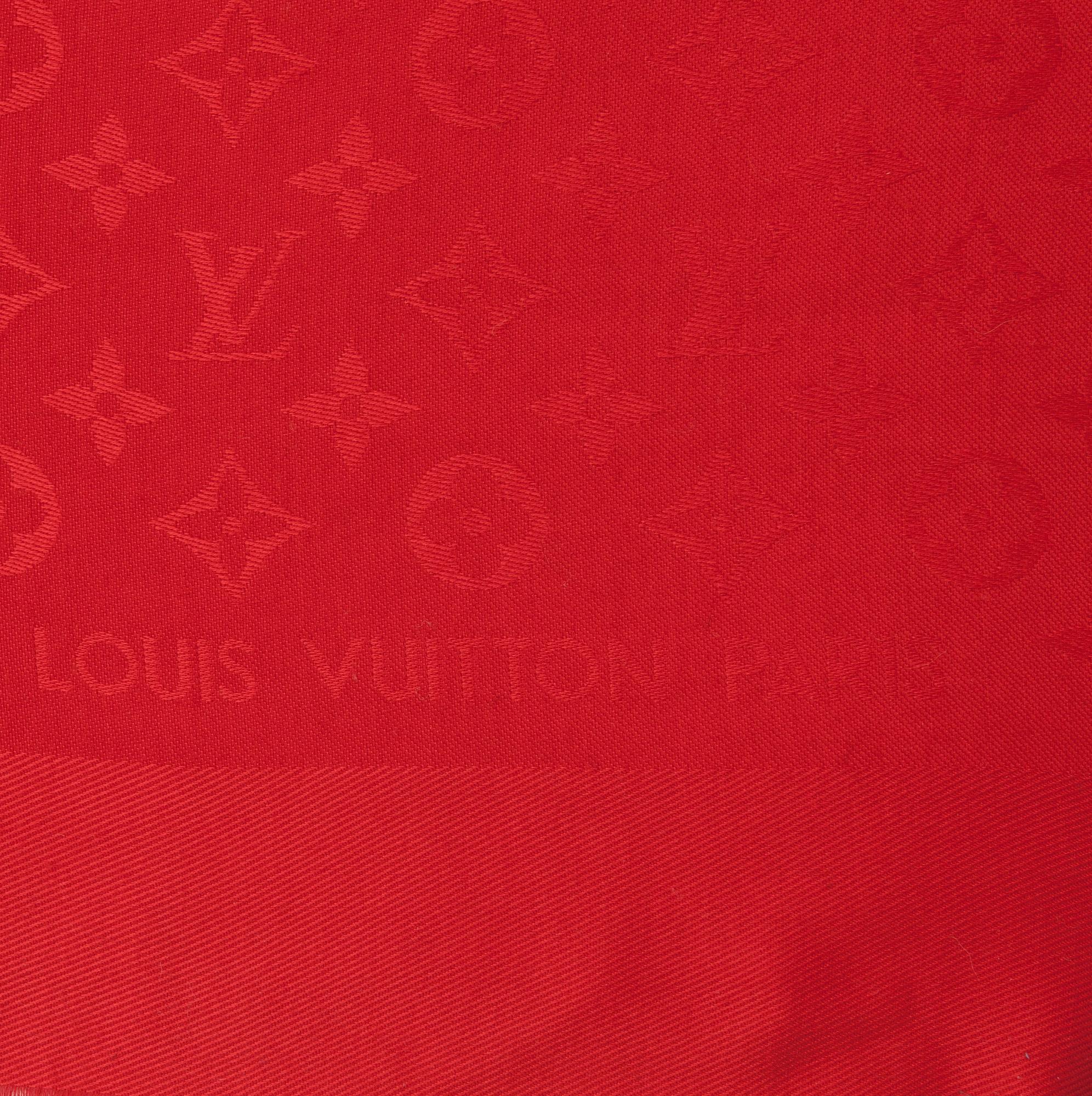 LOUIS VUITTON, a red monogrammed wool and silk shawl.