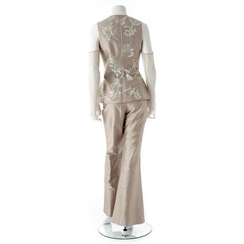 GIANFRANCO FERRÉ, a beige three-piece ensemble consisting of vest , trousers and skirt.