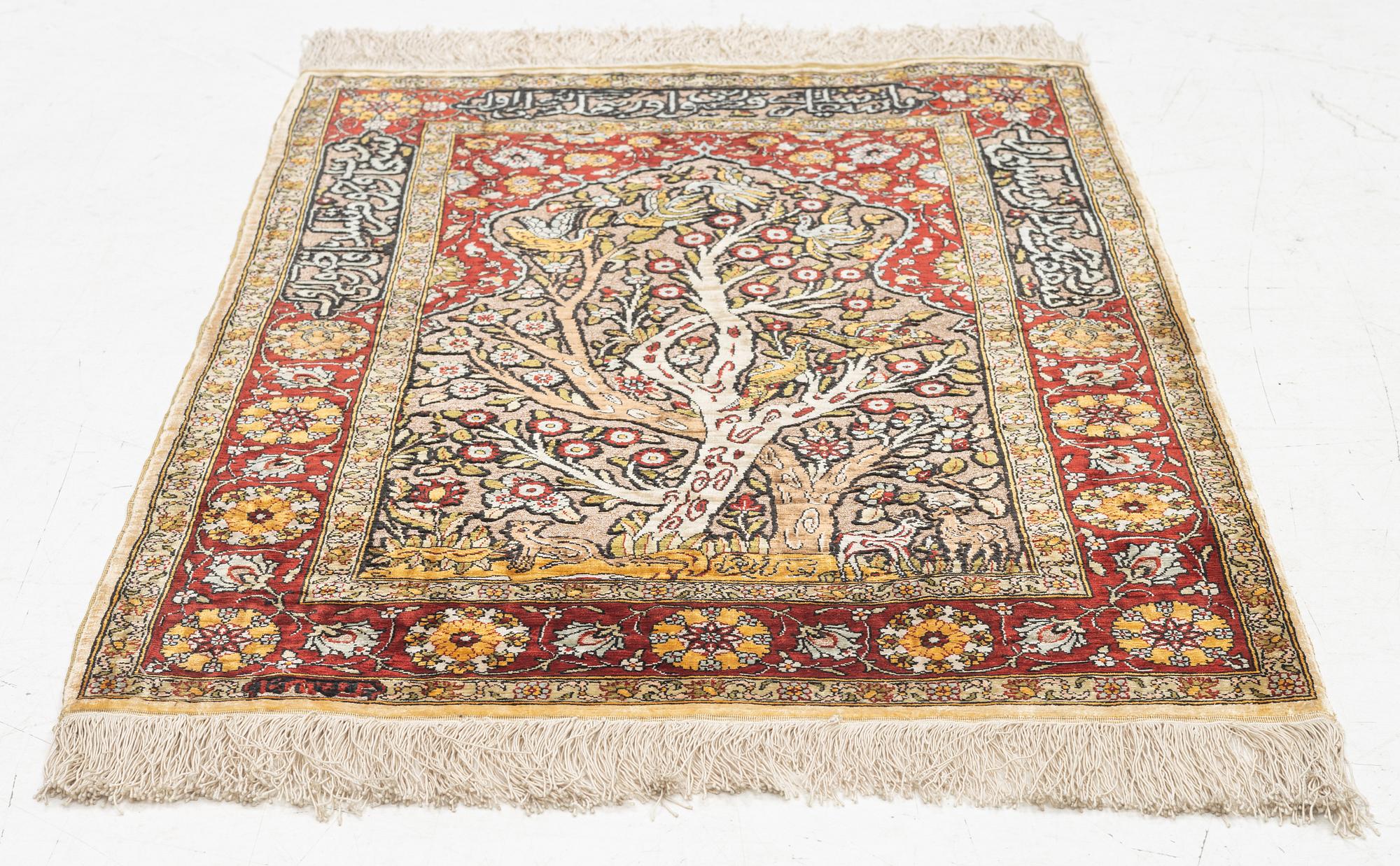 A silke rug, Hereke, signed, c. 90 x 61 cm.