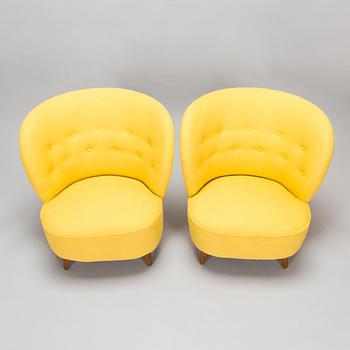 A pair of mid-20th-century armchairs.