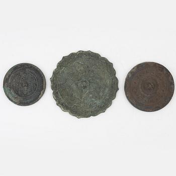 A set of three bronze mirrors, Han dynasty and later.