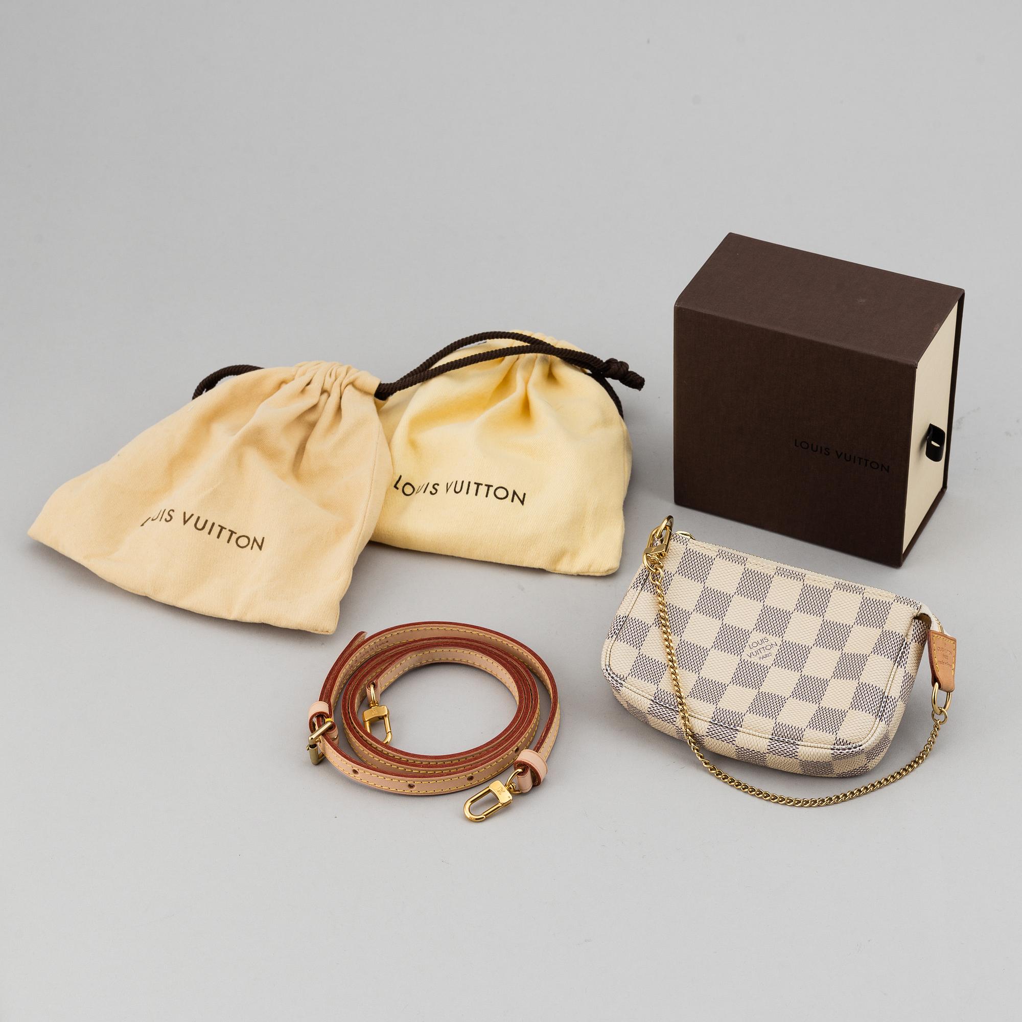 LOUIS VUITTON, A 'Mini Pochette Accessoires' and a shoulder strap.