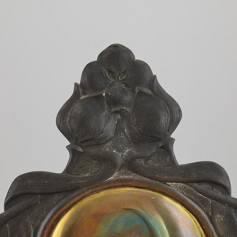 A pair of bronze and brass wall sconces from the early 20th century.