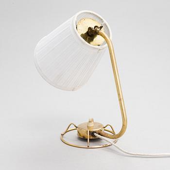A mid-20th-century table lamp
/wall light for Idman.
