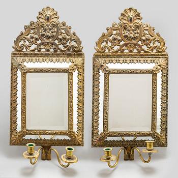 An early 20th Century pair of baroque style mirror sconses.