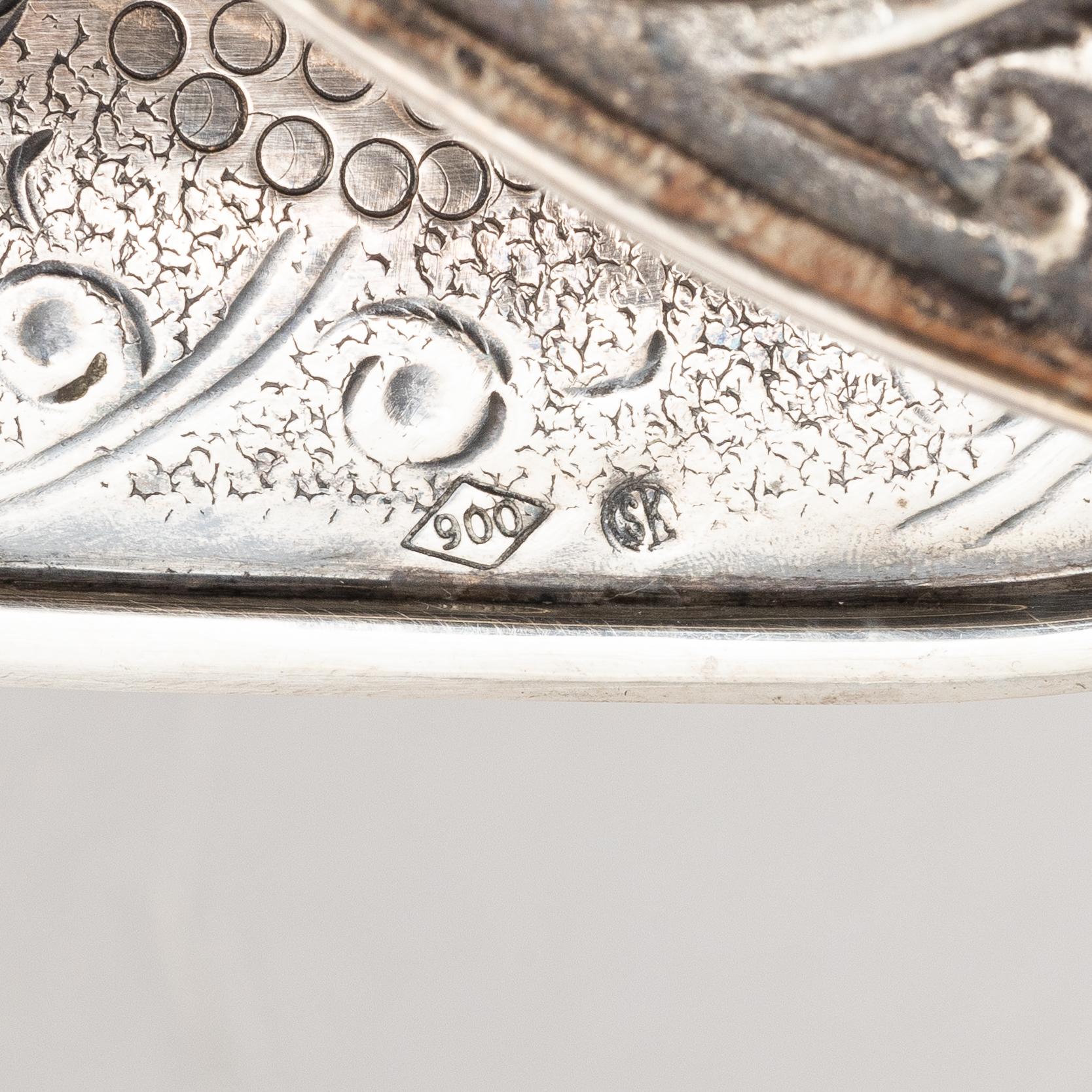 A silver bottle holder with wheels, 20th Century.