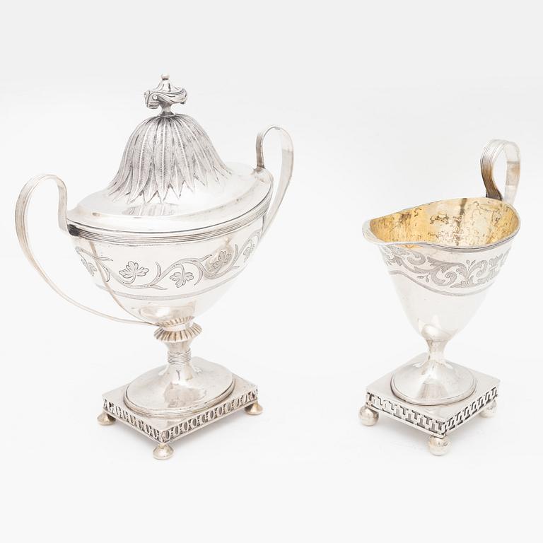 A silver sugarbowl with lid and a creamer, marks of Olof Hellbom, Stockholm, Sweden 1799-1800.