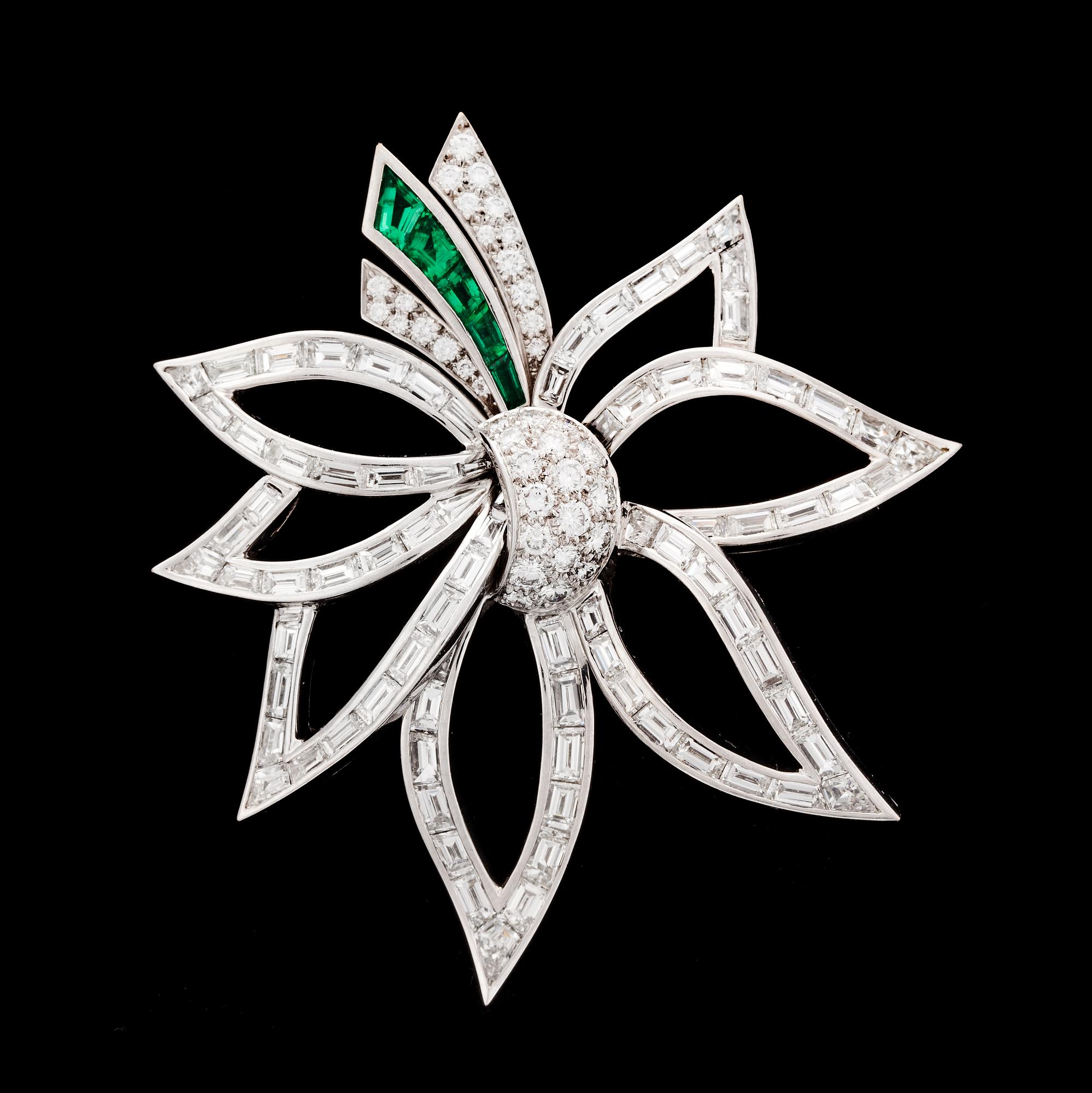 A brilliant cut diamond, tot. app 9 cts, and emerald brooch, 1970's.