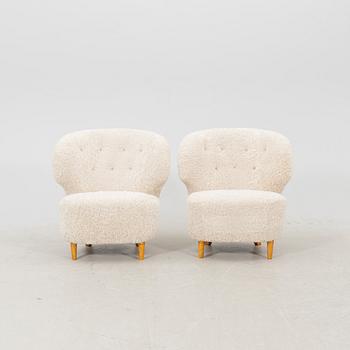A pair of Scandinavian Modern 1940s cheepskin armchairs.