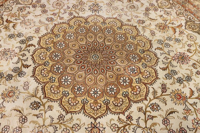 An oriental silk rug, diameter c. 216 cm.