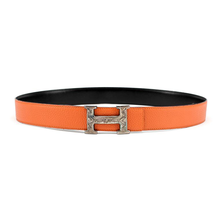 HERMÈS, a reversible belt, togo orange and black leather with silver colored H belt buckle.