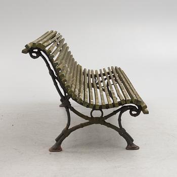 A cast iron-frame garden sofa, circa 1900.