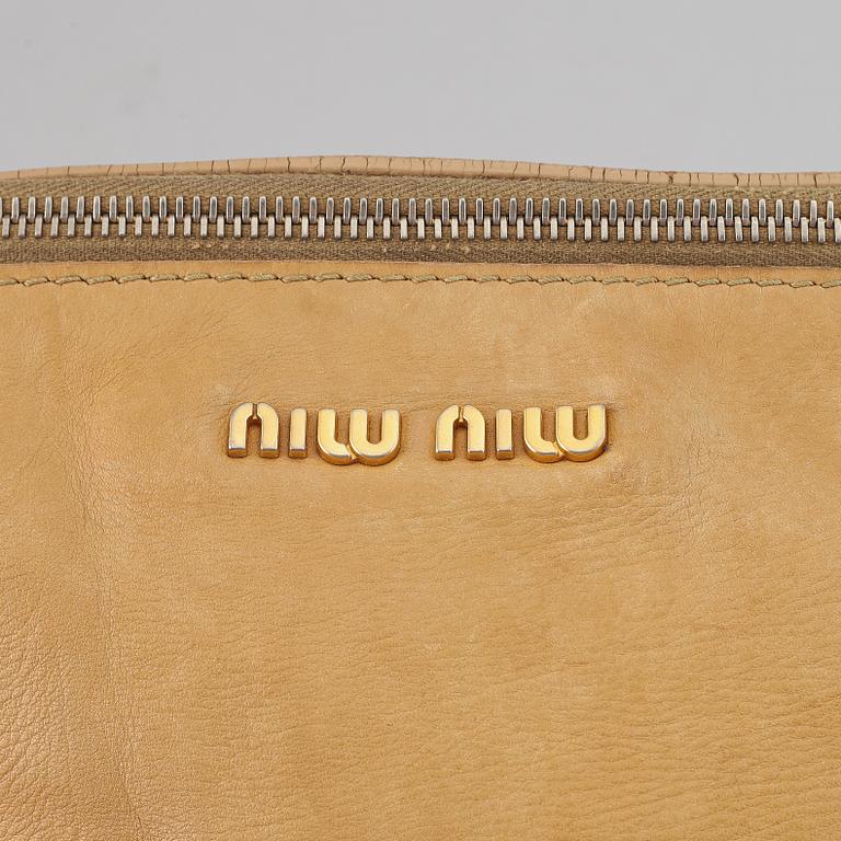 Miu Miu, a leather handbag.