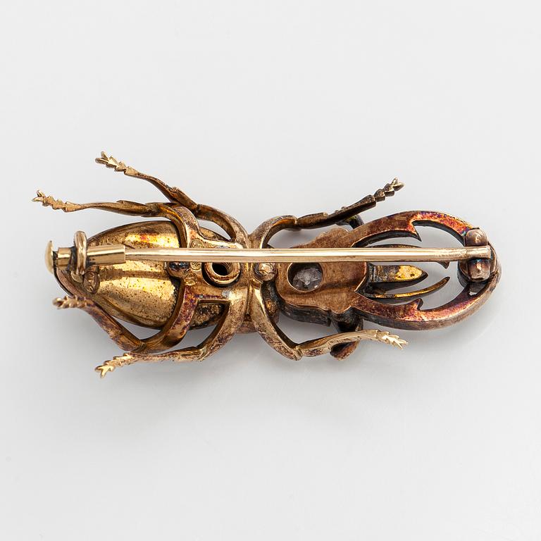 A 14K gold brooch with tiger’s eye, old-cut and rose-cut diamonds, ruby, emeralds. St. Petersburg.