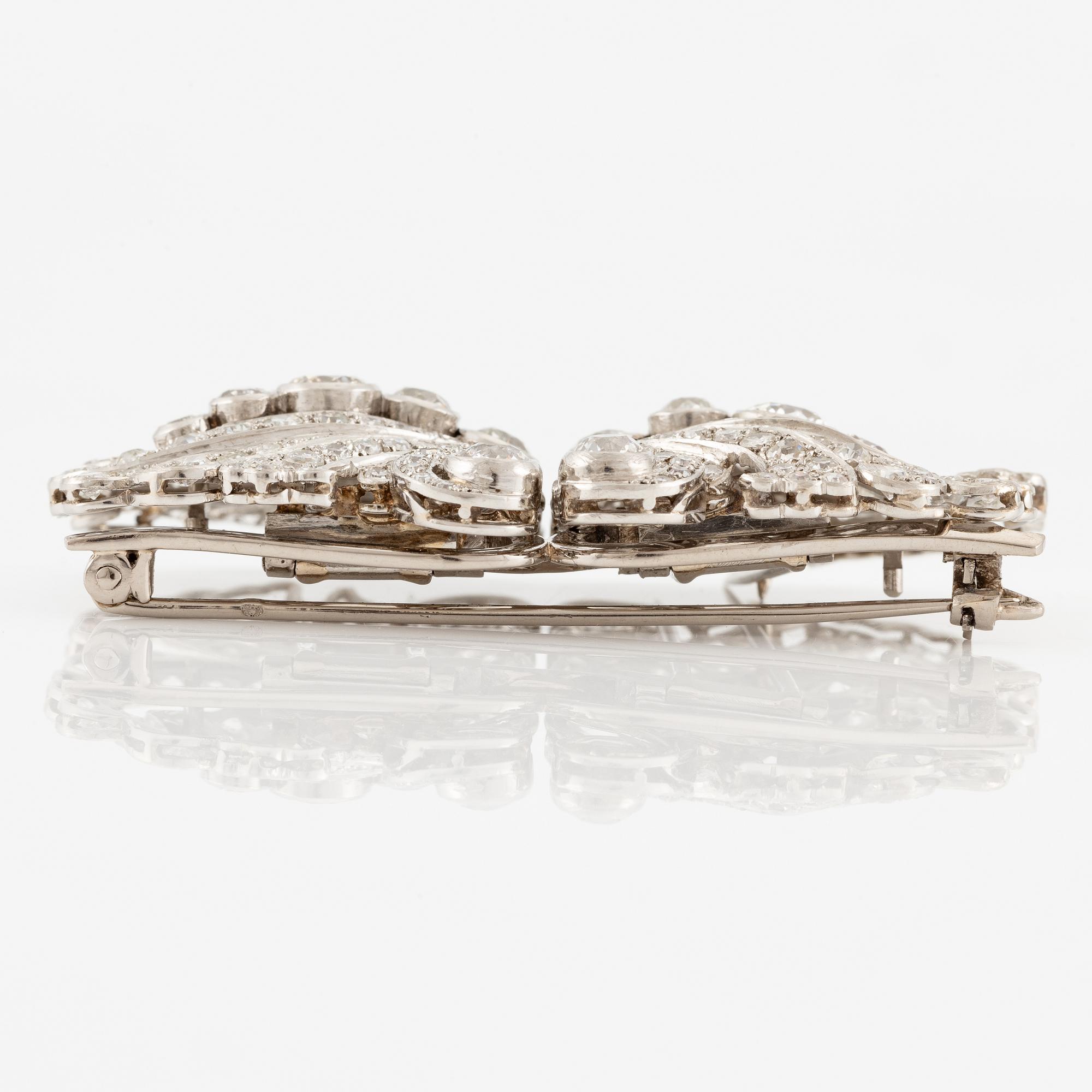 A brooch/double clip in platinum set with old- and eight cut diamonds.