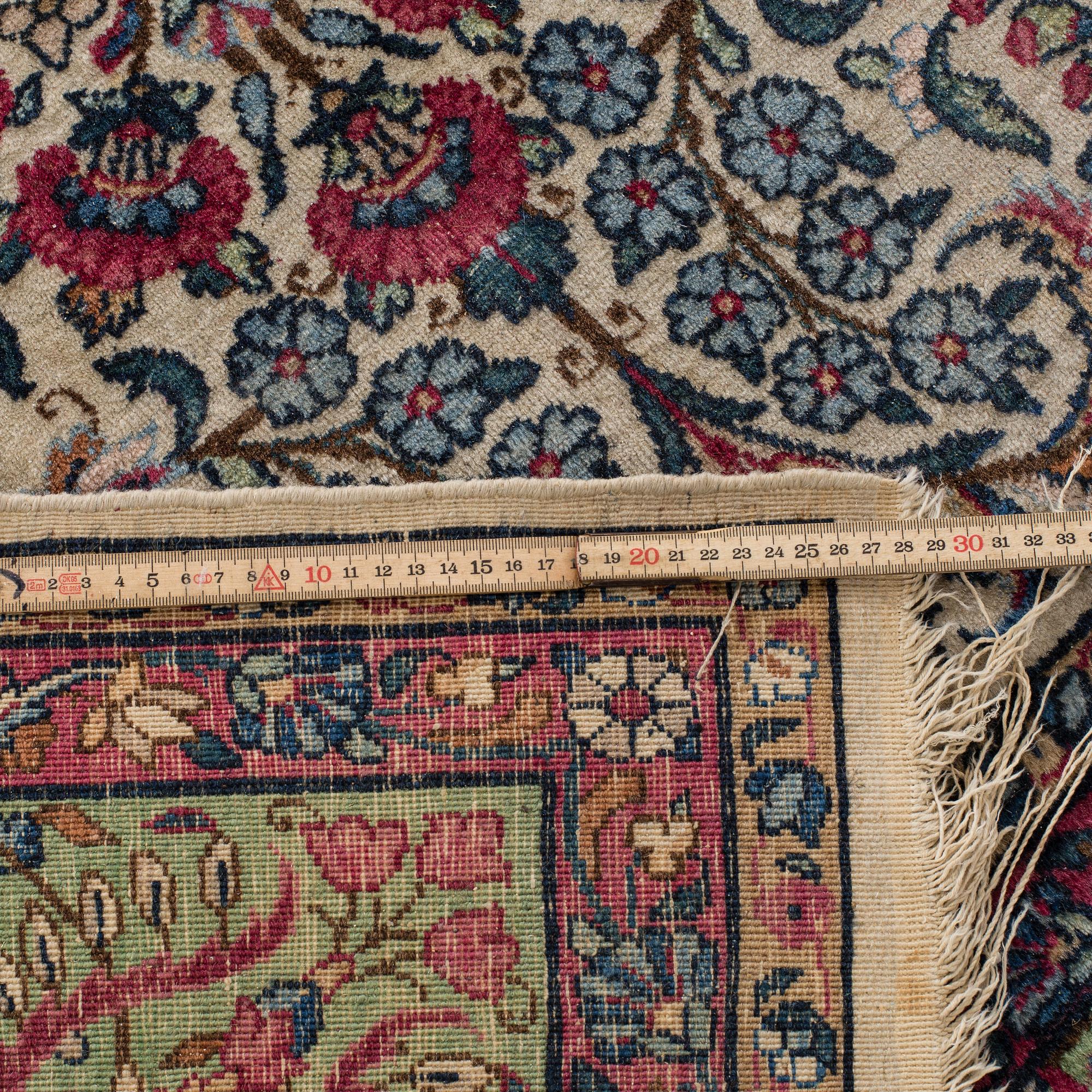 A SEMI-ANTIQUE KIRMAN RUG. 294X205.