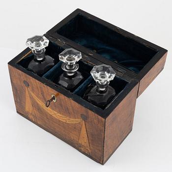A box with three glass bottles, first half of the 19th Century.