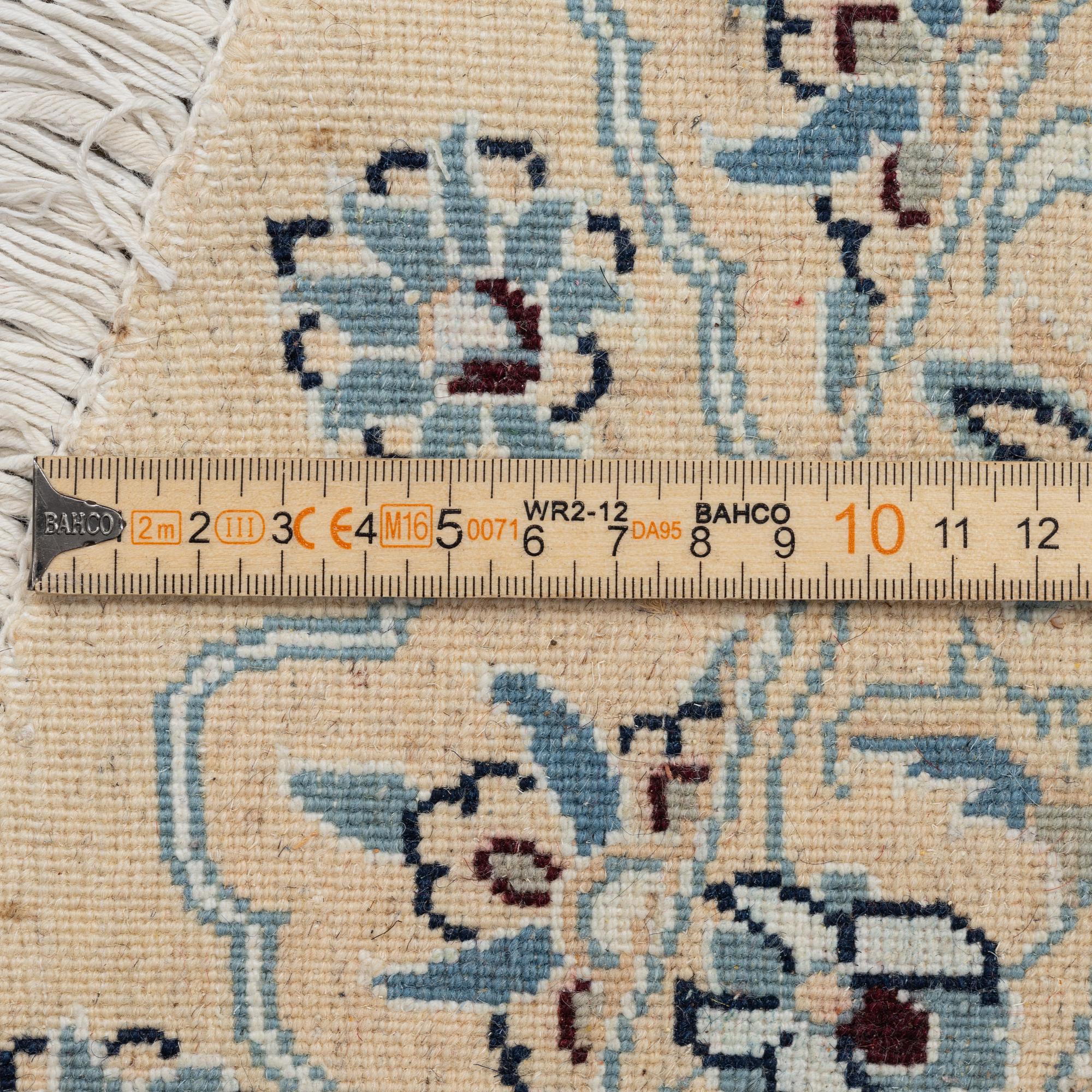 A Nain rug, diameter 243 cm.