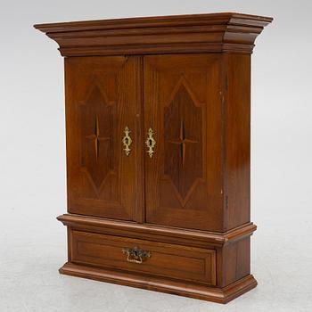 A Baroque style hanging cabinet, late 19th century with earlier parts.