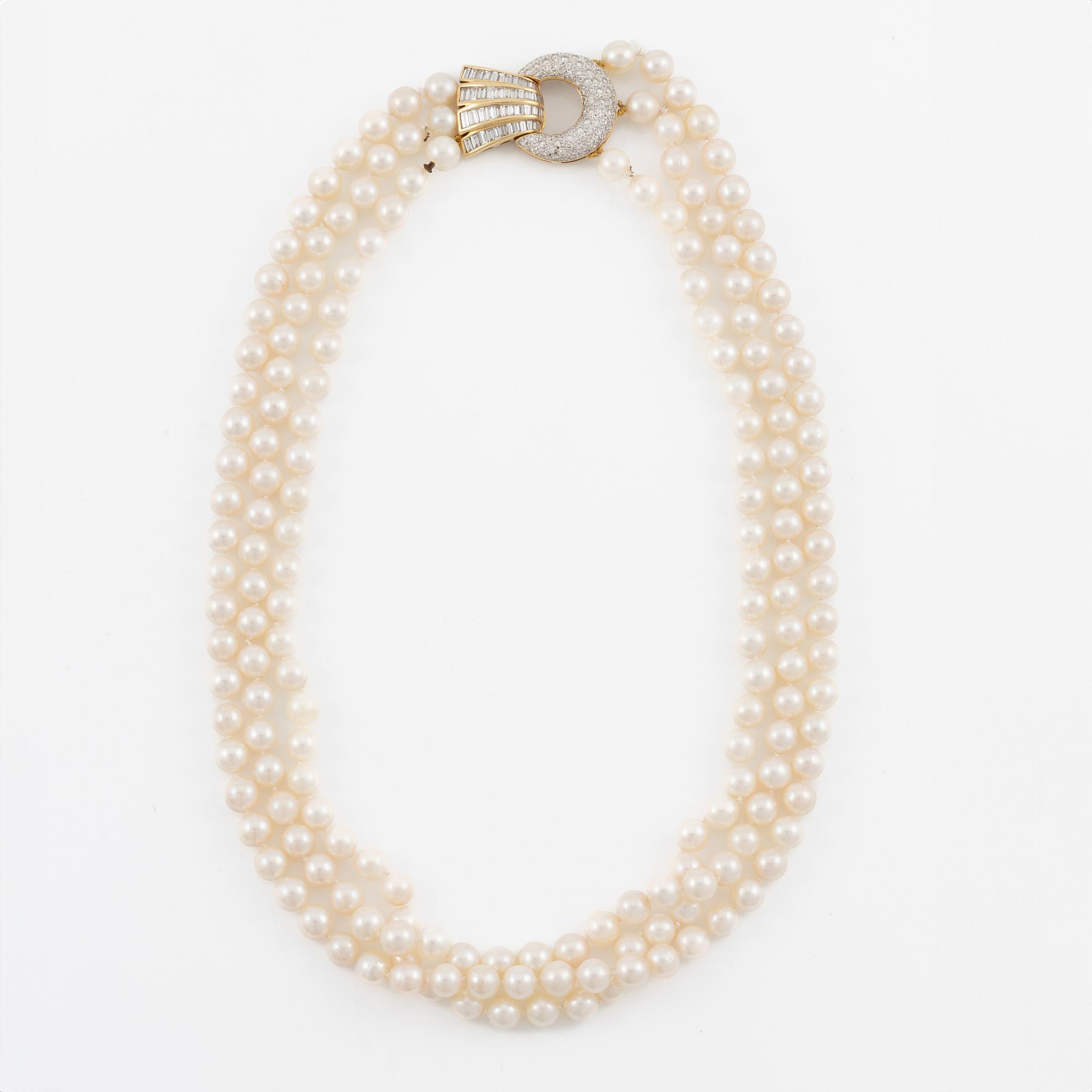 Pearl necklace, three strands of cultured pearls, clasp in 18K gold set with baguette and brilliant-cut diamonds.