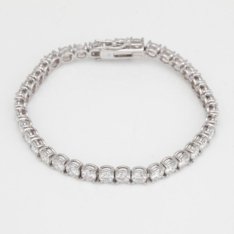 A line bracelet with 37 brilliant cut diamonds. Total carat weight 12.00cts.