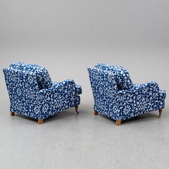 A pair of easy chairs and a stool.