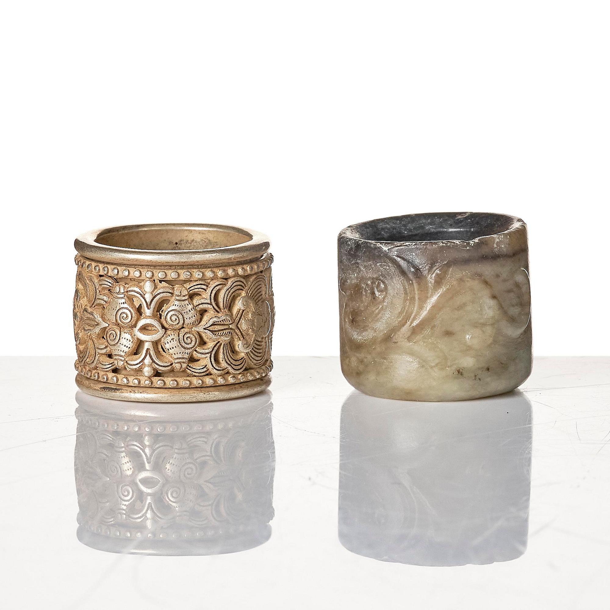 Two archers rings and two nephrite carvings.