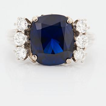 952. A RING set with a faceted sapphire.