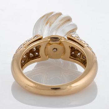 A Boucheron ring set with a carved rock crystal, a cabochon-cut emerald and round brilliant-cut diamonds.