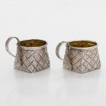 A silver and glass bottle with eight silver charka, maker marks of Pyotr Yermolajevich Davidov, Saint Petersburg, 1884.