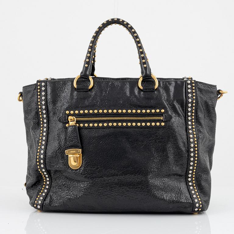 Prada, A black leather and gold stud bag.