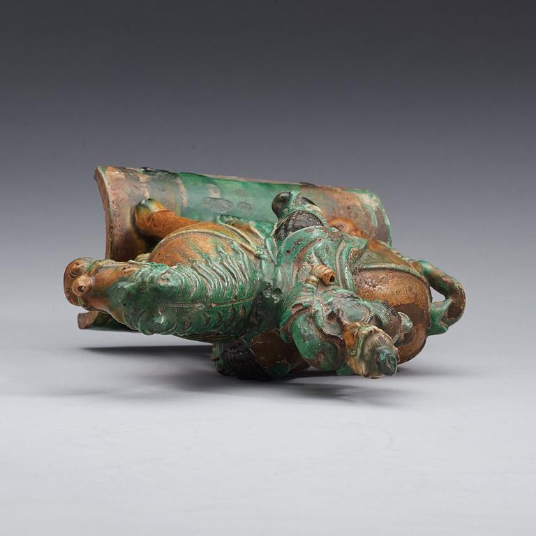 A green and brown glazed ridge tile figure of Guan Yu riding a horse, Ming dynasty  17th century.