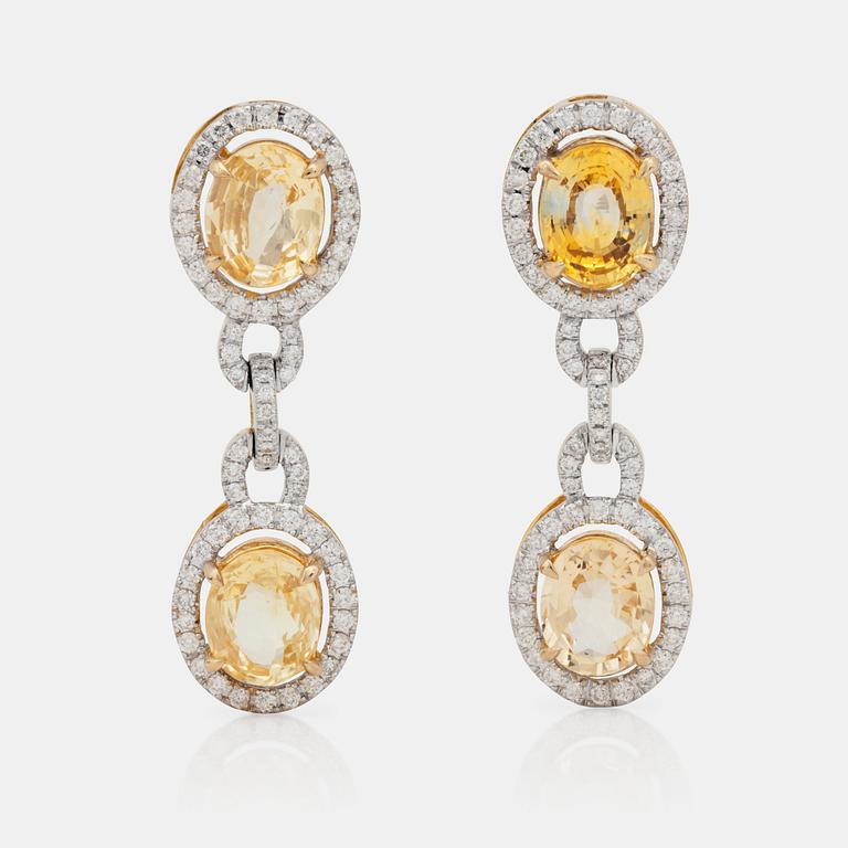 A pair of 6.79ct yellow sapphire and 0.99ct diamond earrings.