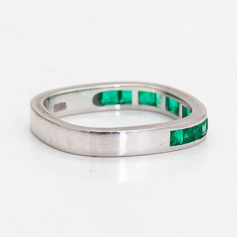 An 18K white gold eternity ring, with square-cut emeralds, Switzerland.