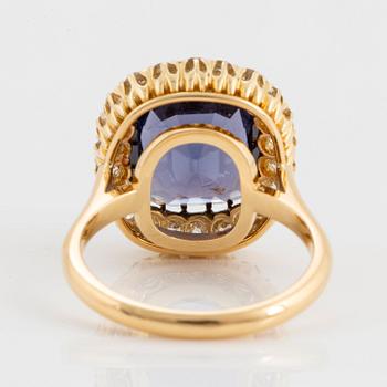 An 18K gold ring set with a cushion-cut purple spinel 6.15 cts according to information given.