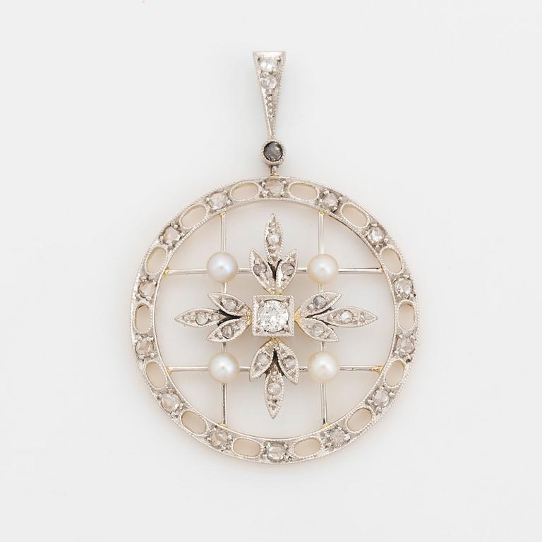 A platinum and gold pendant set with old- and rose-cut diamonds and pearls.