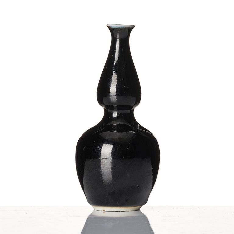 A calebass shaped black glazed vase, Qing dynasty, 19th century.