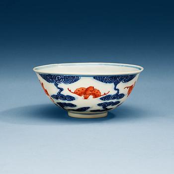 1526. A blue and white bowl with bats in copper red, late Qing dynasty with Quangxu  six character mark.